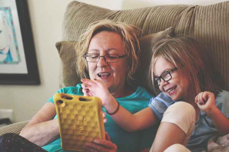 woman and girl using tablet computer